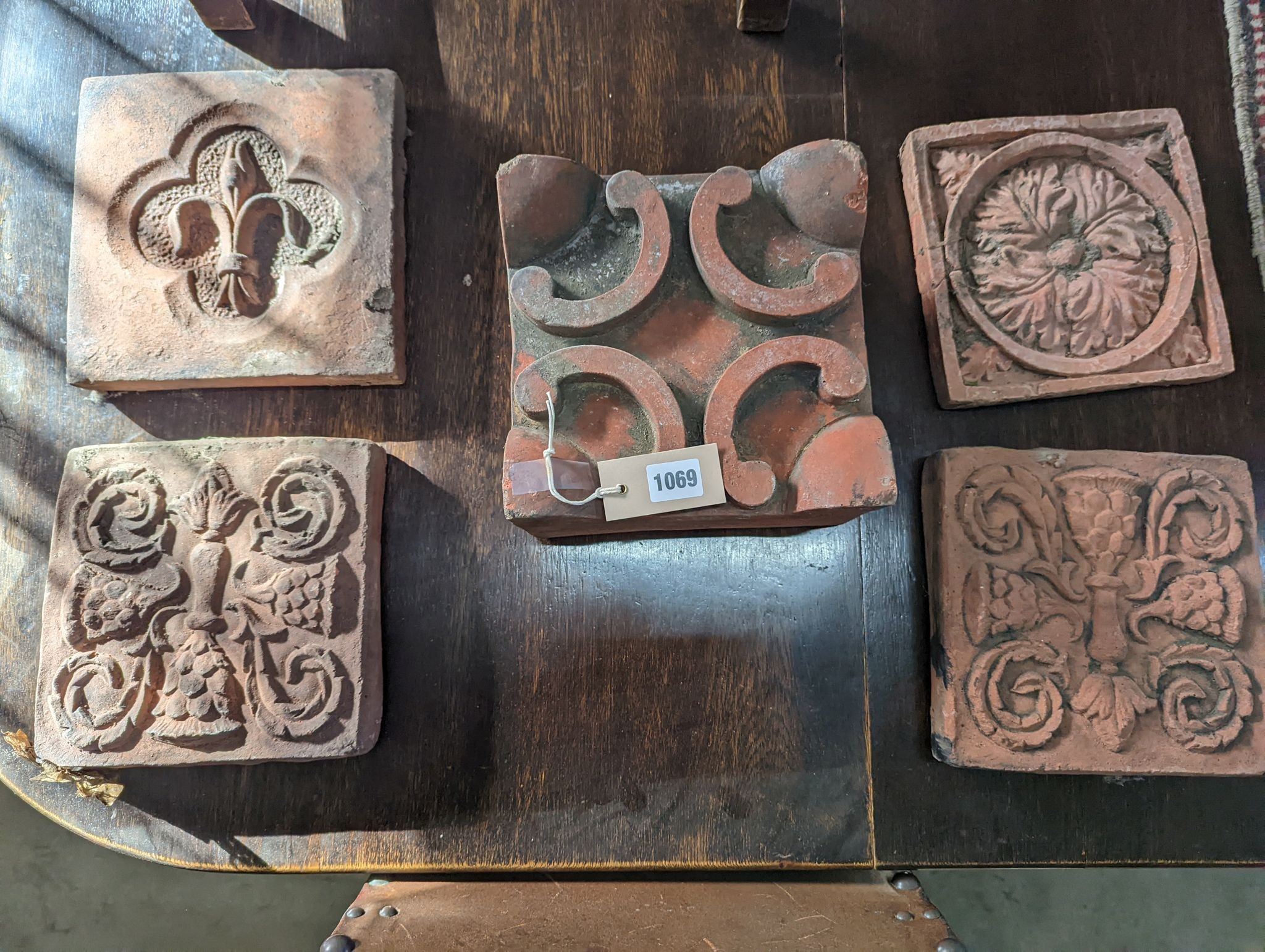 Five square terracotta garden tiles, largest width 22cm, depth 14cm